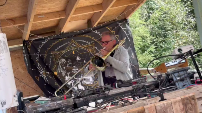 Jack Newhorse playing live ambient trombone at a private outdoor event